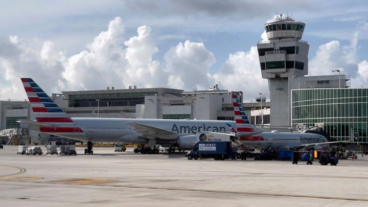 American Airlines` passenger opens door, walk in the wing