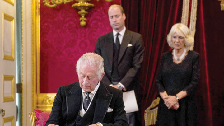 Britain's Prince William, Prince of Wales (centre) and Britain's Camilla, Queen Consort (right) watch as Britain's King Charles III signs an oath to uphold the security of the Church in Scotland, during a meeting of the Accession Council inside St James's Palace in London on Saturday, to proclaim him as the new King (AFP photo)