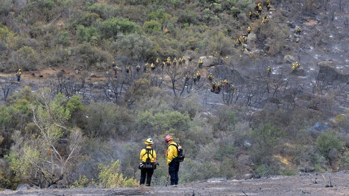 Fire captains watch as firefighters create a barrier to slow the progress of the Fairview Fire inside the San Bernardino National Forest near Hemet, California on September 9, 2022. The wildfire burning outside Los Angeles has doubled in size in less than 24 hours, firefighters said on September 8 as they endured yet another day of blistering heat in the western US. Thousands of people have been told to evacuate in the face of the growing fire, which has now spread to 19,000 acres (7,700 hectare