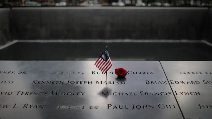 An American flag and red rose stand in the names of those lost at the edge of the south reflecting pool of the 9/11 Memorial & Museum ahead of the 20th anniversary of the 9/11 attacks in Lower Manhattan in New York City, September 8, 2021 Reuters