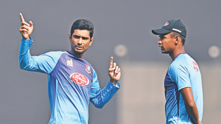 Bangladesh T20I skipper Mahmudullah Riyad talking to Mustafizur Rahman during a practice session. PHOTO: AFP File