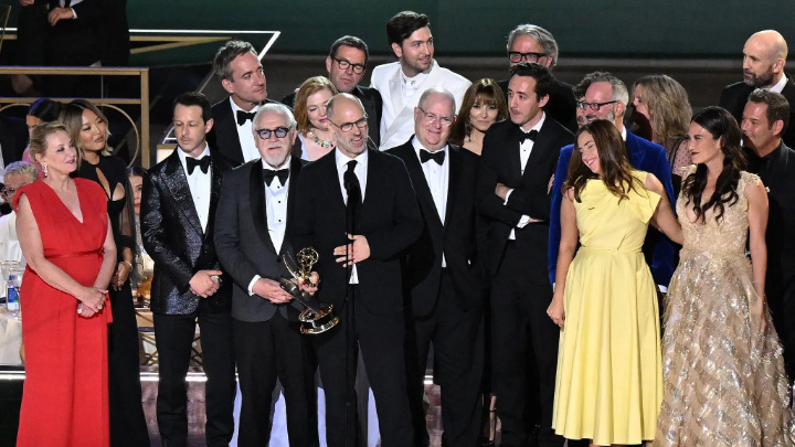 Jesse Armstrong, the creator of “Succession,” with the cast accepting the Emmy for best drama on Monday night.Credit...Patrick T. Fallon/Agence France-Presse — Getty Images