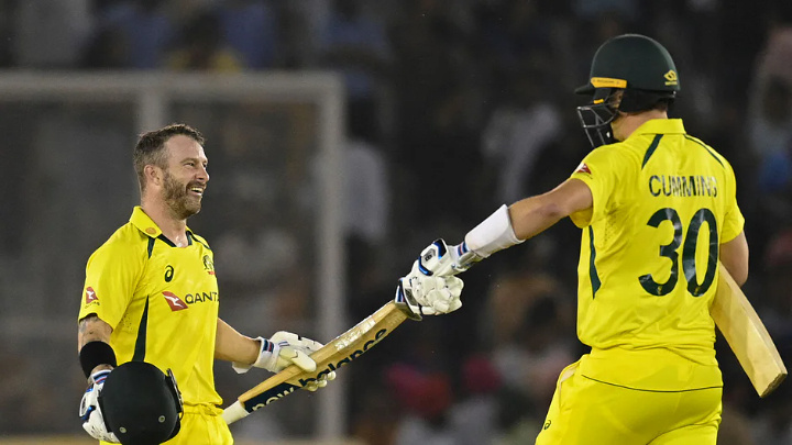 Australia's Matthew Wade (L) celebrates with teammate Pat Cummins after winning the first Twenty20 international cricket match between India and Australia at the Punjab Cricket Association Stadium in Mohali on 20 September, 2022AFP
