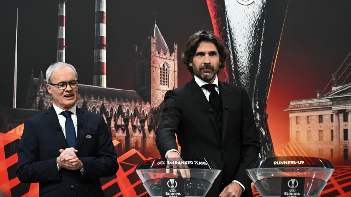 Julien Escude (R), UEFA Europa League ambassador and former French football player, handles draw balls alongside UEFA Deputy General Secretary, Giorgio Marchetti, during the UEFA Europa League knockout stage play-off draw at the House of European Football in Nyon on December 18, 2023. Photo: AFP