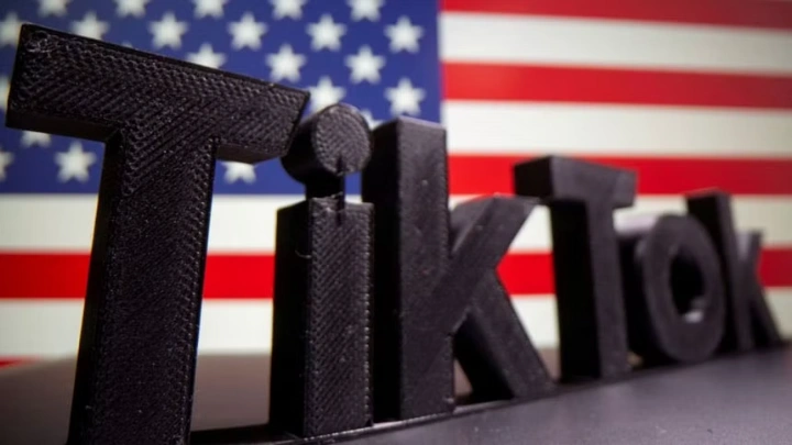 A 3D printed Tik Tok logo is seen in front of US flag in this illustration taken October 6, 2020. Picture taken October 6, 2020. REUTERS/Dado Ruvic/Illustration