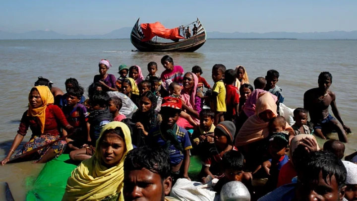 Rohingya refugees sit on a makeshift boat on 9 November 2017. Reuters file photo