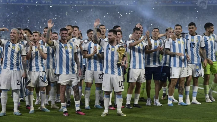 Argentina superstar Lionel Messi holds a replica of the World Cup trophy during a recognition ceremony for the World Cup-winning players, following the friendly match against Curacao at the Madre de Ciudades stadium in Santiago del Estero, in northern Argentina, on March 28, 2023. PHOTO: AFP