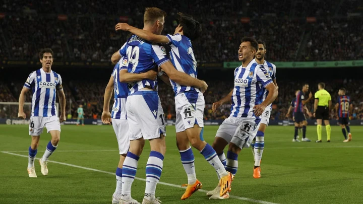 Real Sociedad's Alexander Sorloth celebrates with Takefusa Kubo and teammates after scoring their second goal against Barcelona on May 20, 2023. PHOTO: Reuters