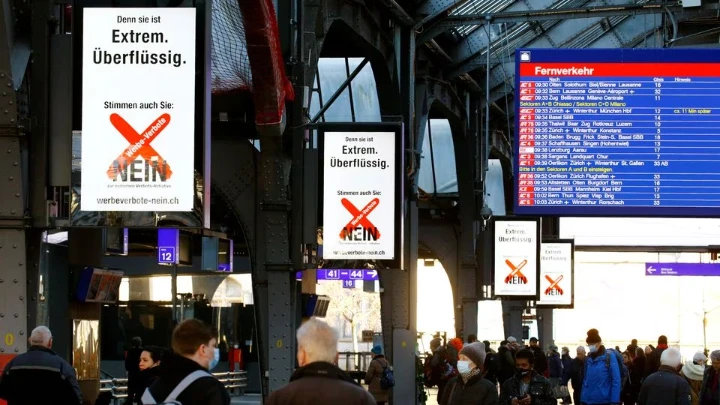 Displays read "Because it is: Extreme. Superfluous. Vote no to the extreme advertising ban initiative" before an upcoming vote to decide on the ban of tobacco advertising, at the central railway station in Zurich, Switzerland February 10, 2022. REUTERS/Arnd Wiegmann