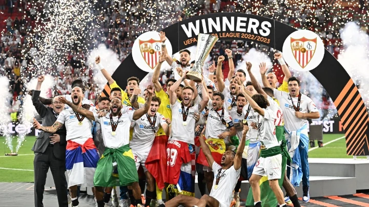 Sevilla players celebrate with the Europa League trophy after winning Wednesday's final against Roma in Budapest AFP