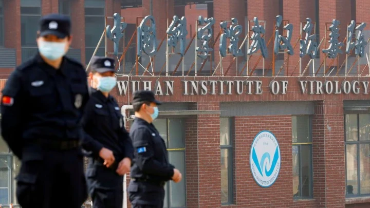 Security personnel keep watch outside the Wuhan Institute of Virology during the visit by the World Health Organization (WHO) team tasked with investigating the origins of the coronavirus disease (COVID-19), in Wuhan, Hubei province, China February 3, 2021. REUTERS/Thomas Peter/File Photo