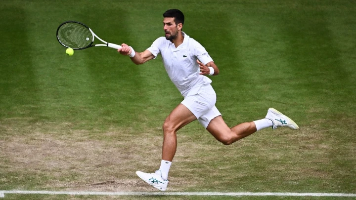 Serbia's Novak Djokovic returns to Russia's Andrey Rublev during Tuesday’s Wimbledon quarter-final in London AFP