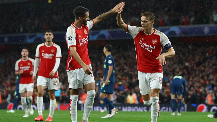 Arsenal's Martin Odegaard celebrates scoring their fourth goal with teammate Fabio Vieira. Photo: Reuters