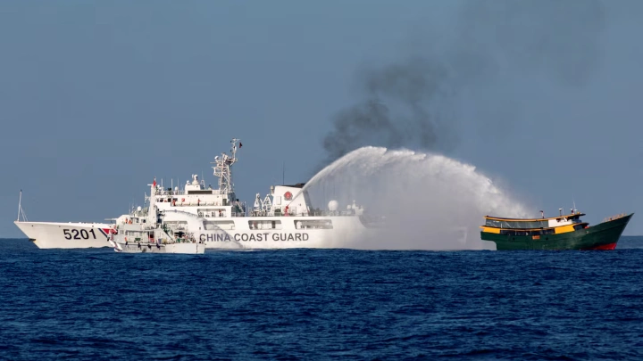 Chinese Coast Guard vessels fire water cannons towards a Philippine resupply vessel Unaizah May 4 on its way to a resupply mission at Second Thomas Shoal in the South China Sea, March 5, 2024. REUTERS/Adrian Portugal/File Photo