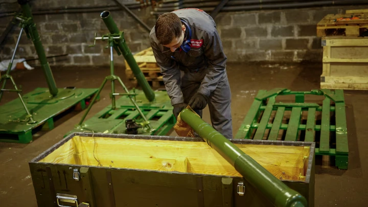 An employee prepares to place a mortar into a box at a production facility of the 'Ukrainian Armor' Design and Manufacturing Company, amid Russia's attack on Ukraine, in an undisclosed location in Ukraine April 9, 2024. REUTERS/Valentyn Ogirenko