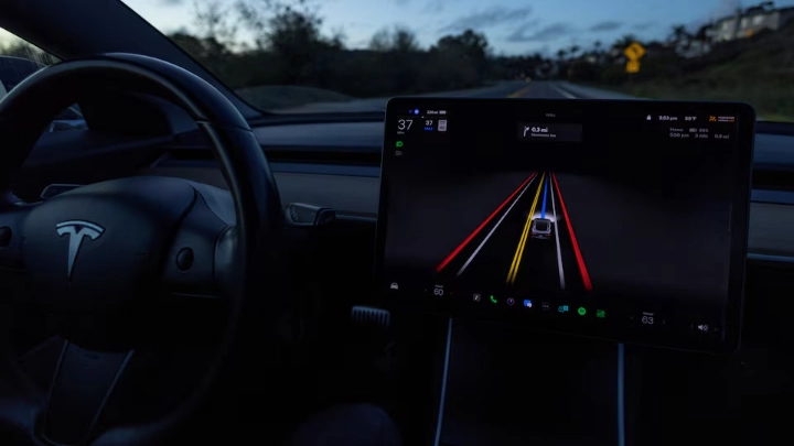 A Tesla Model 3 vehicle is shown using the Full Self Driving Beta software (FSD) while navigating a city road in Encinitas, California, U.S., February 28, 2023. REUTERS/Mike Blake/File Photo