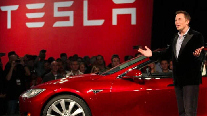 Tesla brings forward new models as profits slump