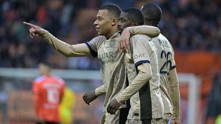 Paris Saint-Germain's forward Kylian Mbappe embraces Ousmane Dembele (C) as they celebrate their victory against FC Lorient at the Stade du Moustoir in Lorient on April 24, 2024. PHOTO: AFP