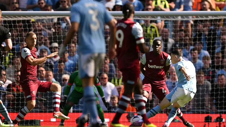 Manchester City's Phil Foden (R) scores the opening goal during the English Premier League football match against West Ham United at the Etihad Stadium in Manchester on May 19, 2024. PHOTO: AFP